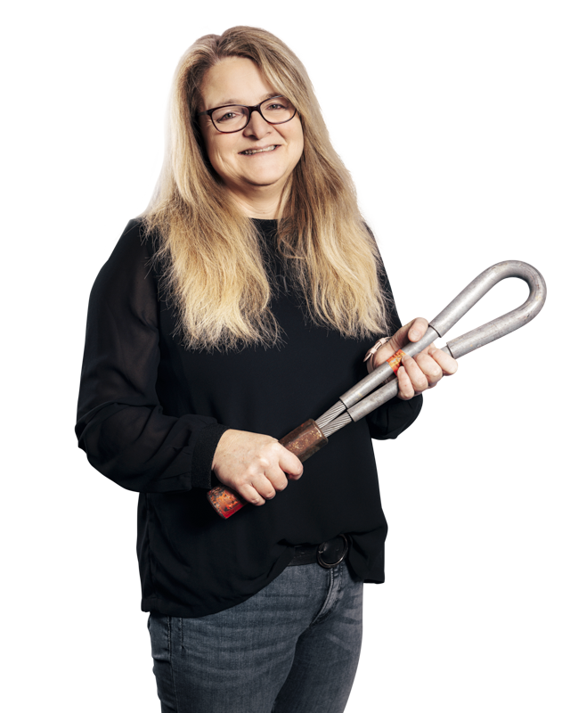 Susanne Alfes, Ansprechpartnerin Baugrubensicherung posiert mit einem Werkzeug in den Händen